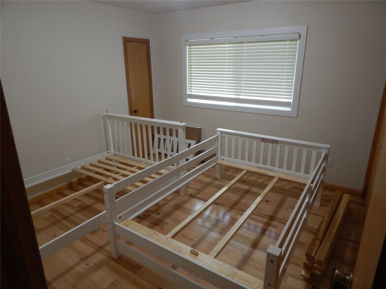 Bedroom #1 with 3 closets and room for two if bunking. - 825 N Dodge St