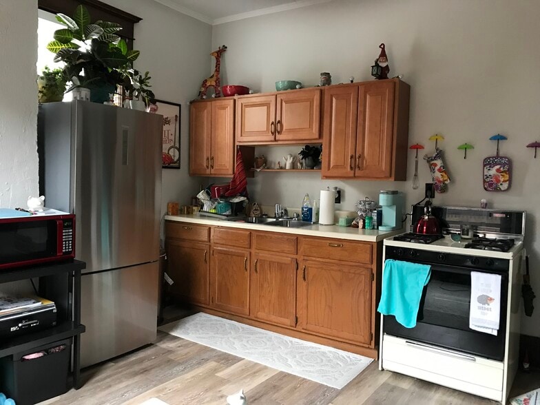Kitchen area (staged) -full-size gas cooktop and full-size newer stainless steel fridge (other pictured appliances not included) - 350 Cobun Avenue