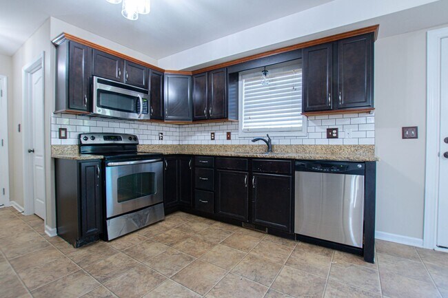 Building Photo - Pet Friendly Three Bedroom with Bonus!