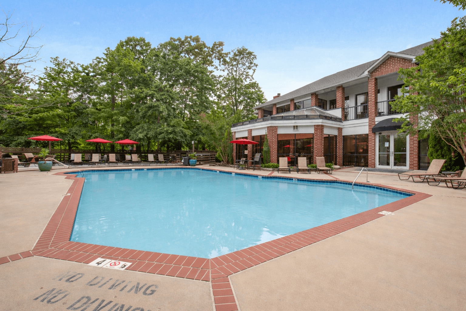 Pool Side Relaxing Area Surrounded by Trees - Rolling Brook Village