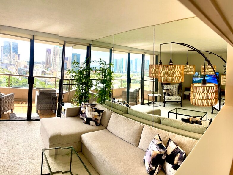 Living room has large L-shape sofa that unfolds to queen bed/storage - 1221 Victoria St
