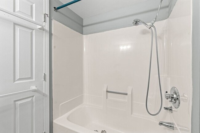 Building Photo - Updated 1BR Condo with Balcony, Garage Parking & Storage Near Commuter Rail