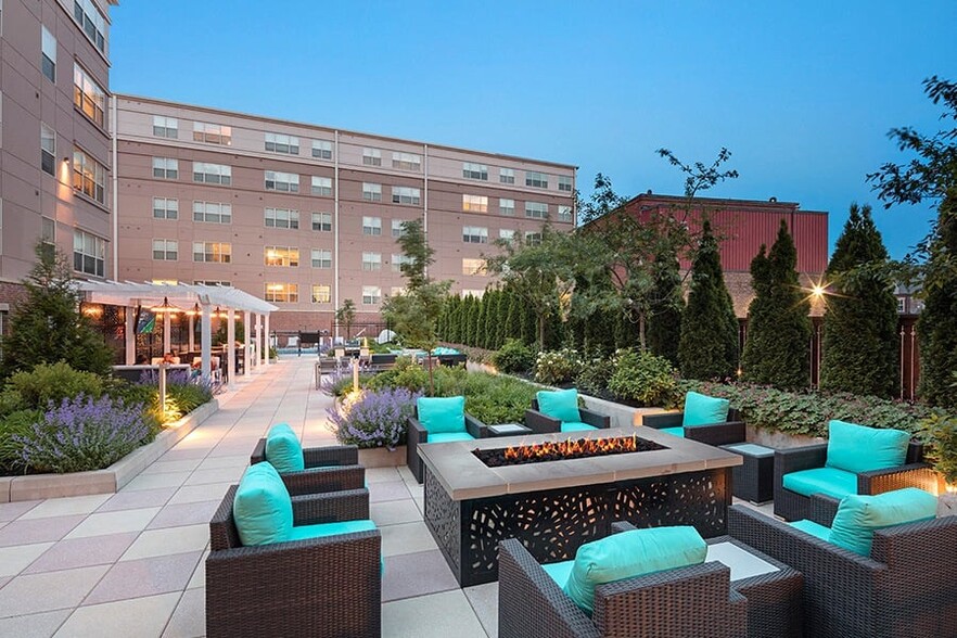 Enjoy the outdoor courtyard with games, fire feature and seating - Malden Square Apartments