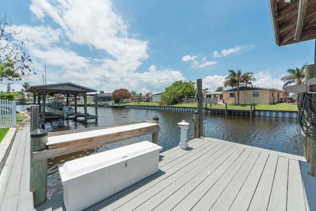 Building Photo - Live the ultimate Space Coast waterfront lifestyle at this stunning beachside canal home in Satel...