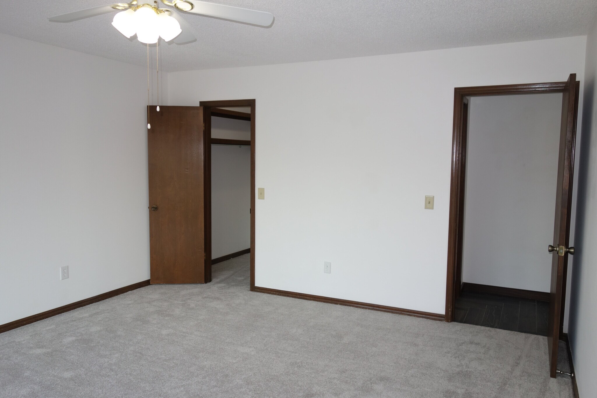 1st bedroom with view of walk-in closet on left and hallway access on right - 3324 E 73rd St