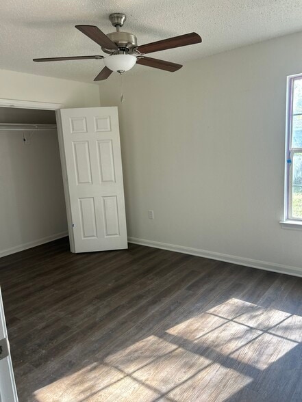 Spacious primary bedroom with roomy closet and modern ceiling fan. - 4720 Burma Rd