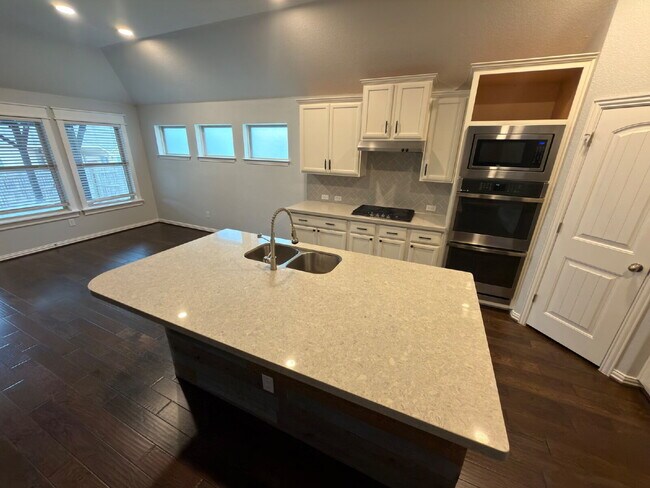 Building Photo - Four bed two bath on a corner lot with a pool in Sunfield. Gas cook top, double ovens. Open kitch...