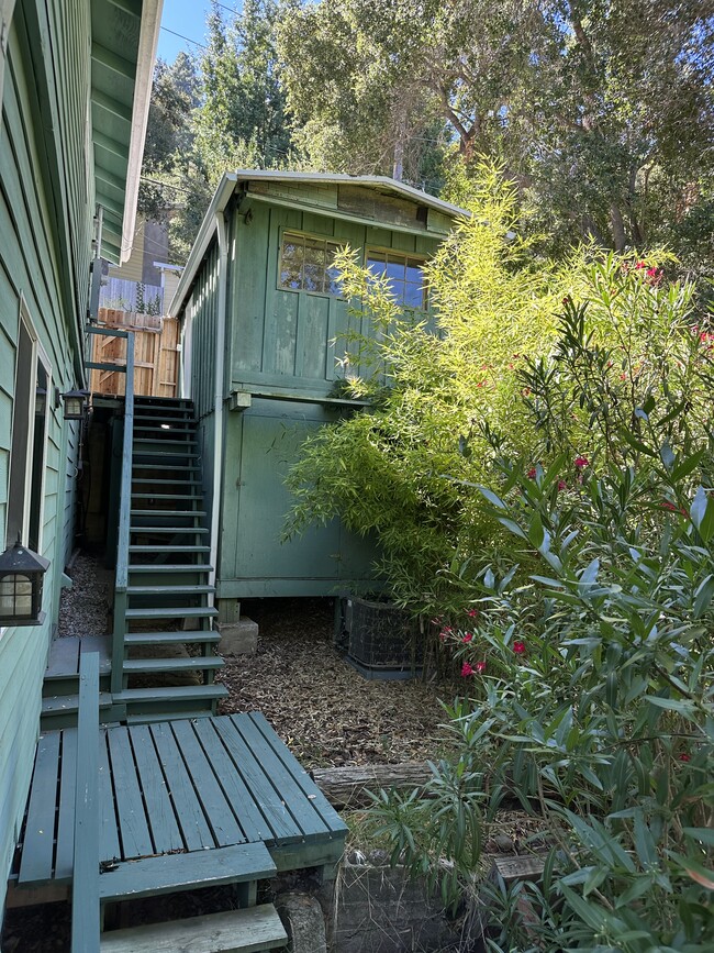 Stairway out downstairs back door, leading to garage studio and front of home - 19876 Observation Dr