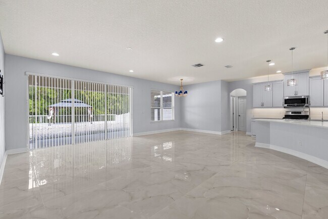 Building Photo - Spacious 6-Bedroom Home Near Lake Nona | 3-Car Garage + Tesla Charger