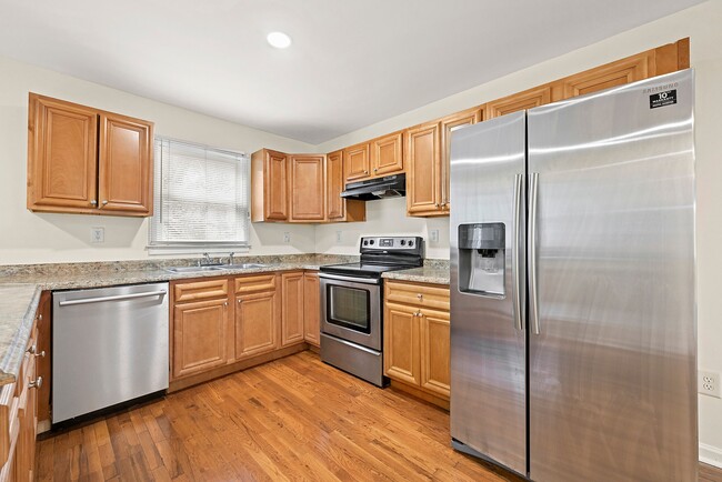 Modern kitchen with stainless steel appliances, ample counter space, and plenty of cabinetry - 247 Farrington Ave SE