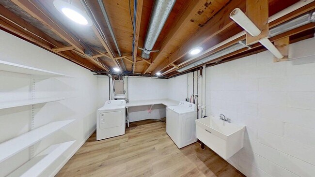 Building Photo - Updated two bedroom duplex, new stainless steel appliances, garage, and hardwood floors