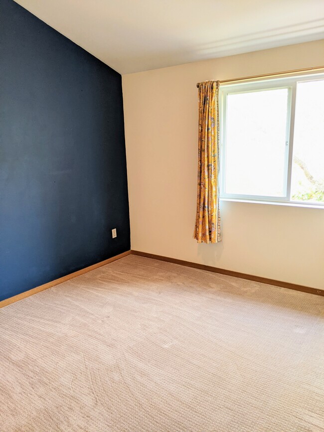 Master bedroom with window that overlooks backyard and trees and open space - 4810 S Holly St