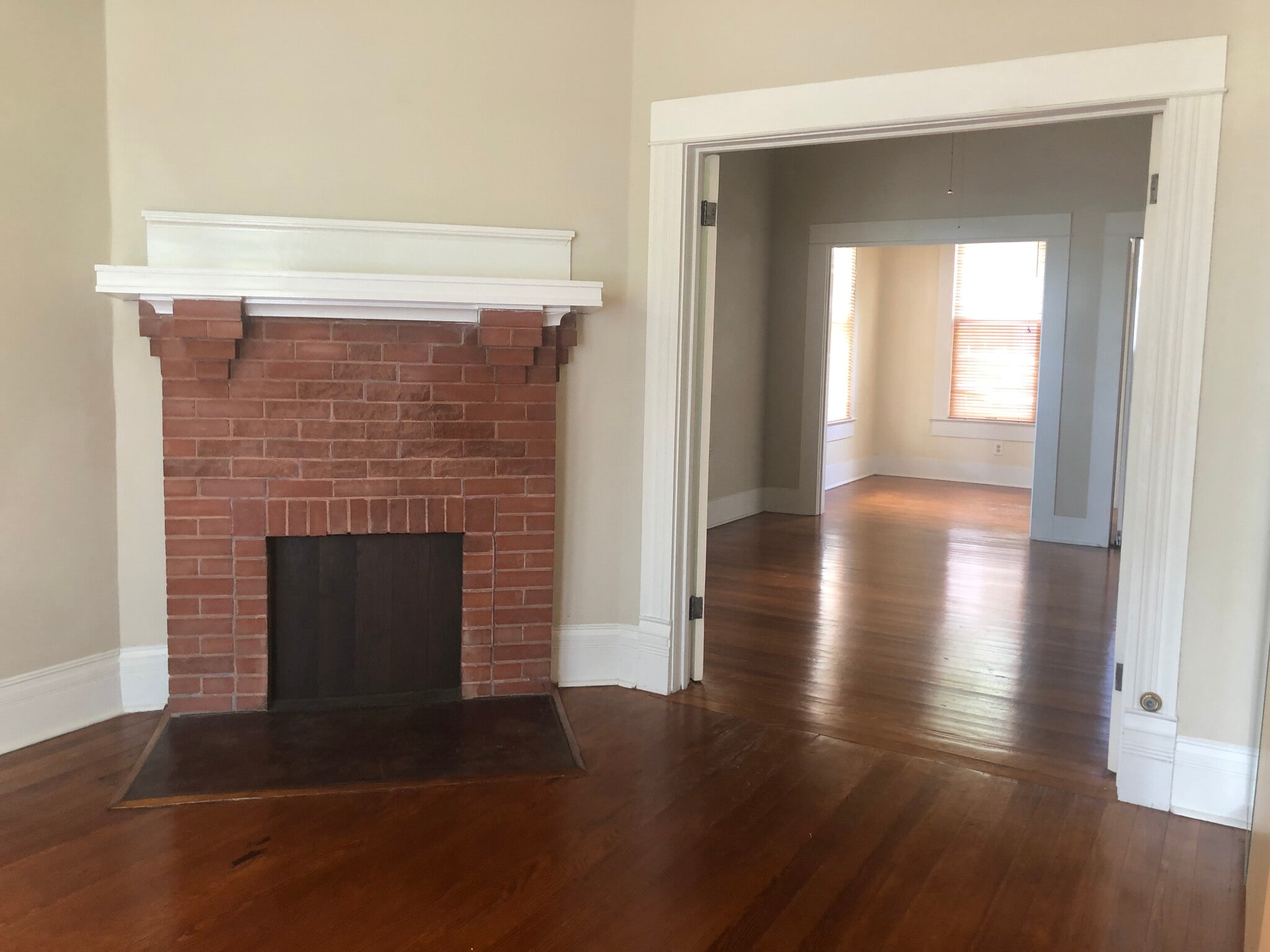 non working fireplace in the large bedroom looking thru the living area to the breakfront room - 704 E Guenther St
