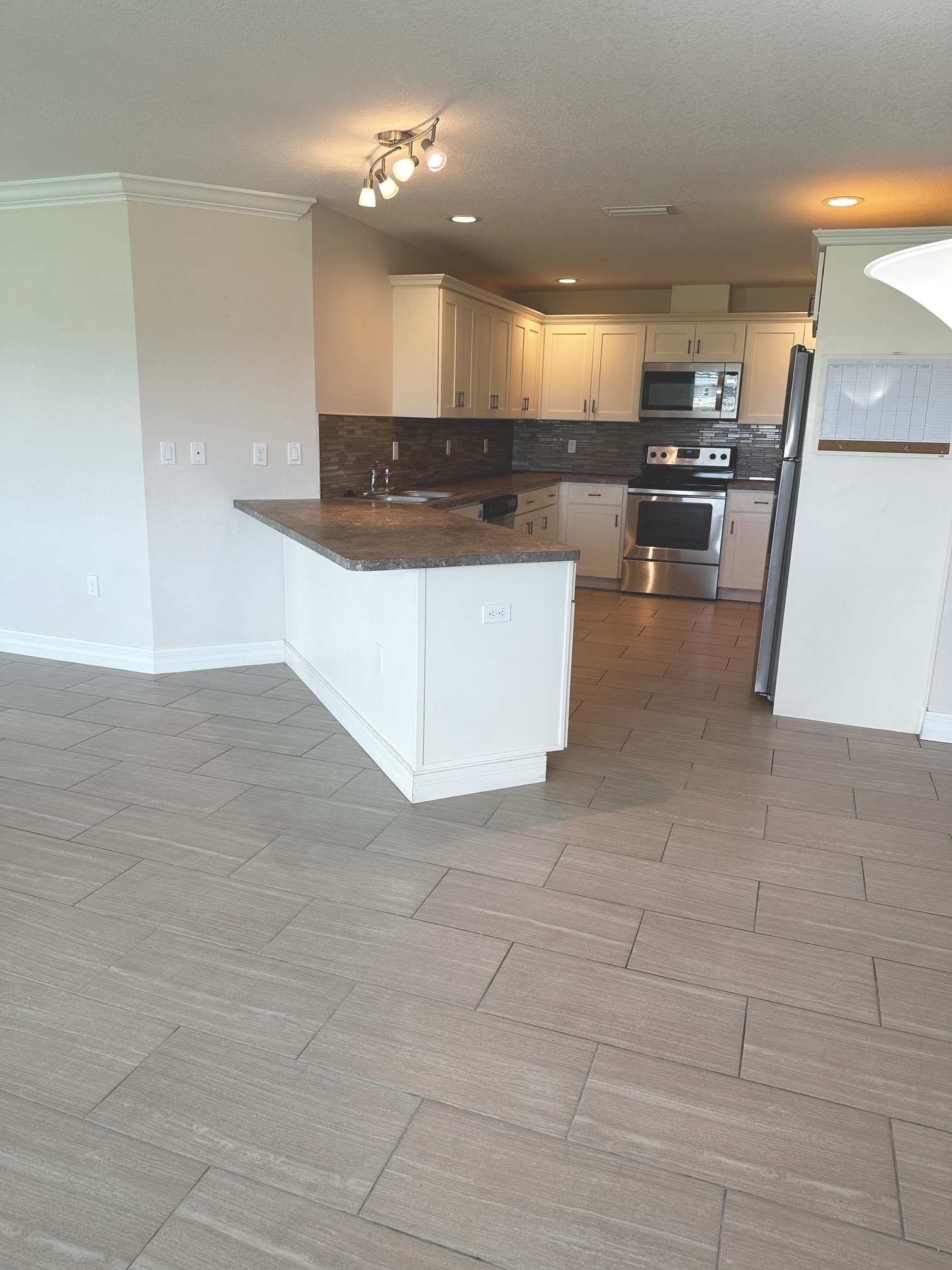 Kitchen has lots of cabinets and tile backsplash - 190 Boundary Blvd