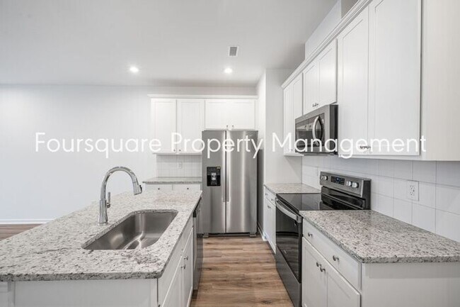 Building Photo - Spacious 3-Bed / 2.5-Bath Townhome with First-Floor Den, Hardwood Floors & 1-Car Garage – Wendell...