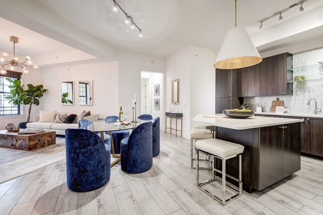 Open living room and kitchen concept with dining area, natural lighting and wood-like finish tile flooring - Cantabria at Turtle Creek