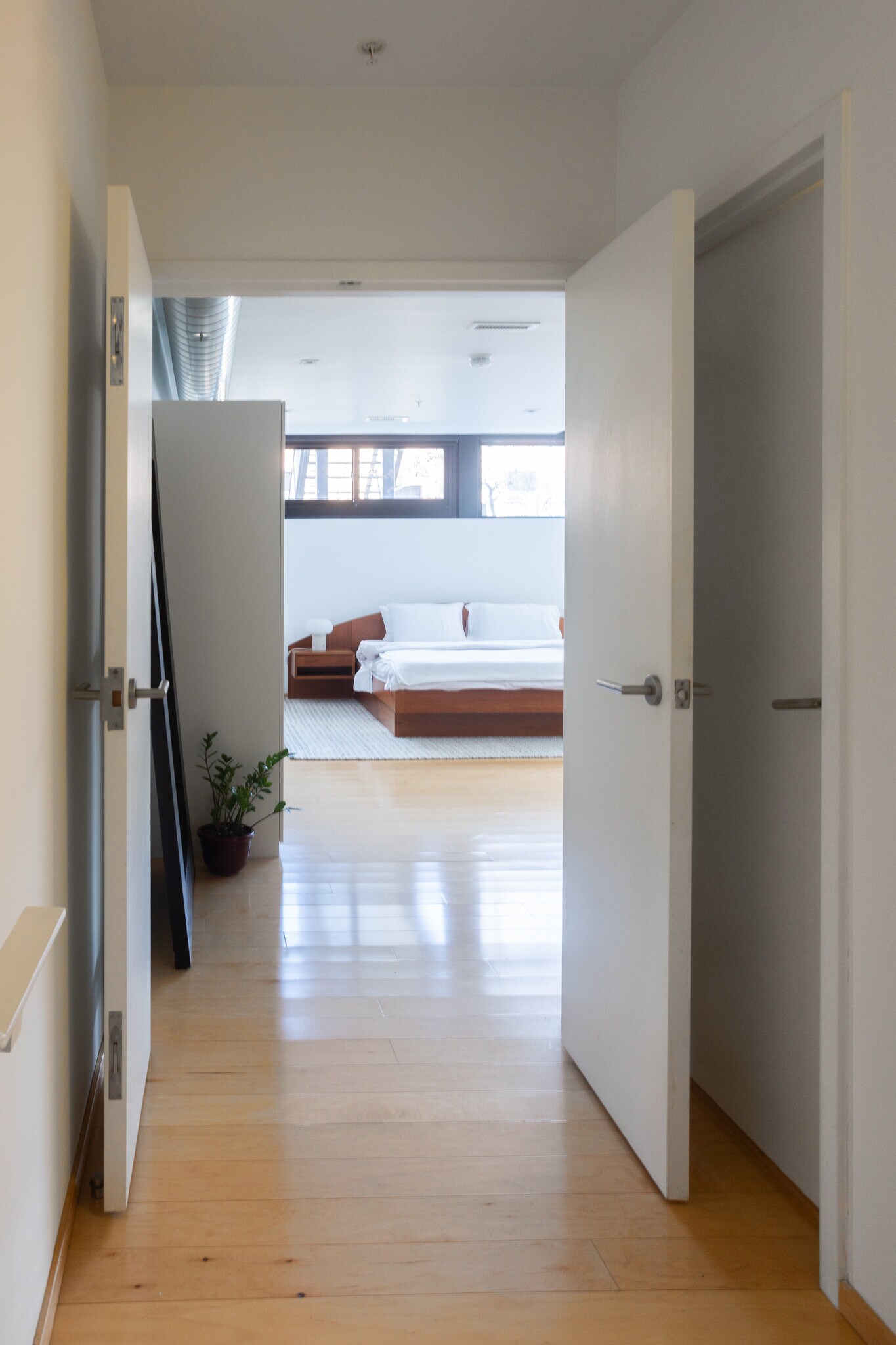 View from the base of the stairwell looking into the primary bedroom. - 2250 11th St NW