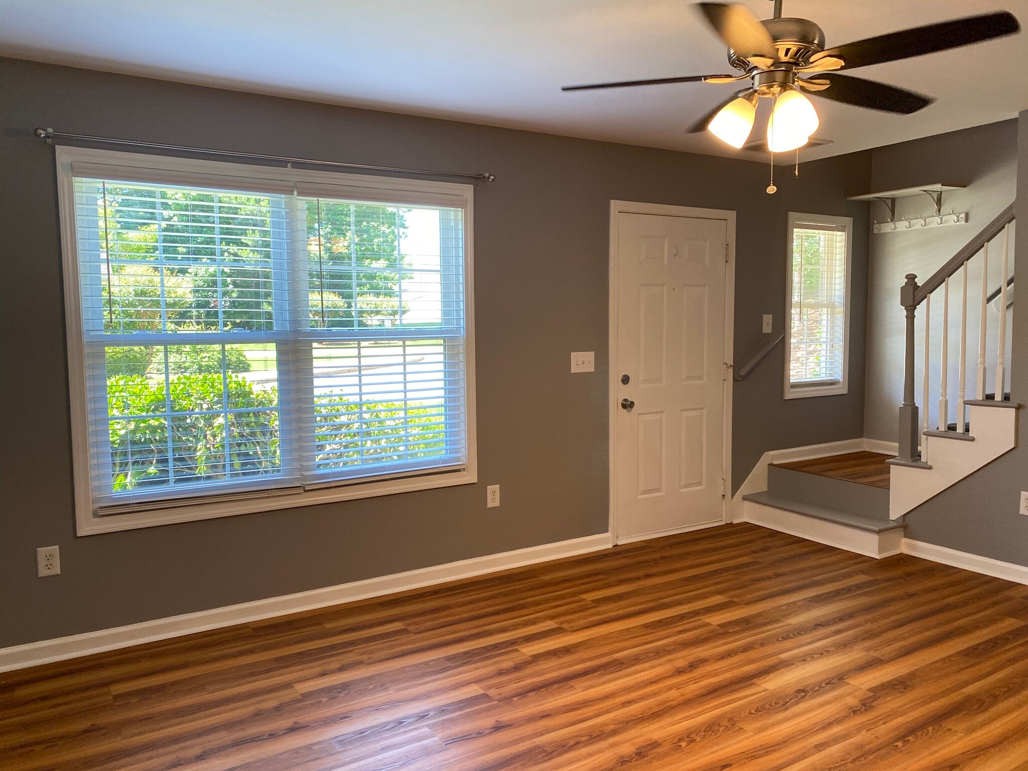 Living room has plenty of space, ceiling fan and vinyl plank flooring. - 1305 Cedar Shoals Drive #500
