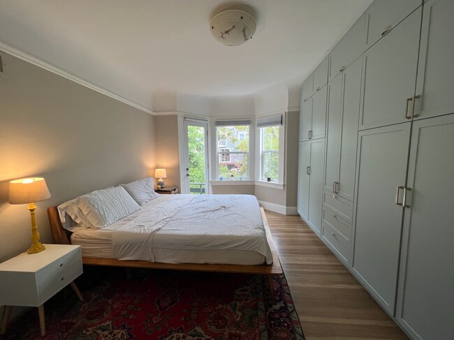 Primary bedroom with Juliette balcony and floor to ceiling closets - 37 Alma St