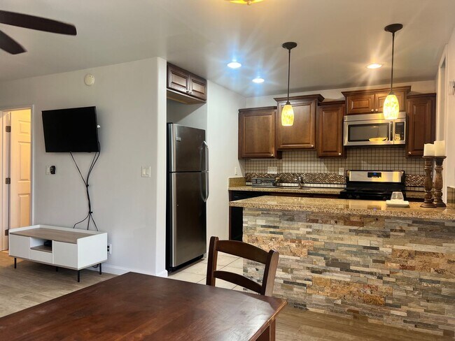 Building Photo - One bedroom semi-furnished bottom floor condo