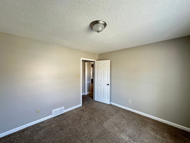 Building Photo - Grand 4BR/2BA Near Southwind | 2,438 Sq Ft, Stone Fireplace, Soaking Tub & 2-Car Garage