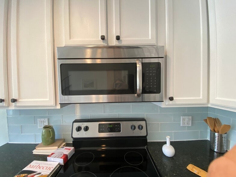 Microwave and backsplash in the kitchen. - 1845 Anaheim Ave