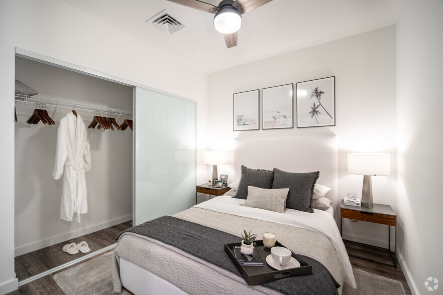 Bedroom with sliding frosted closet doors - The Residences at Bishop Place