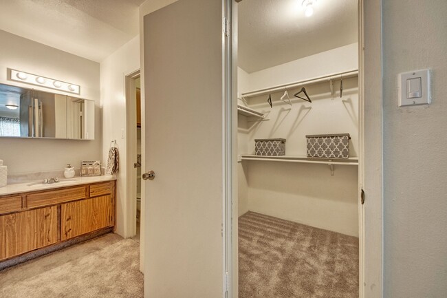 A large bathroom next to a large walk in closet - High Plains