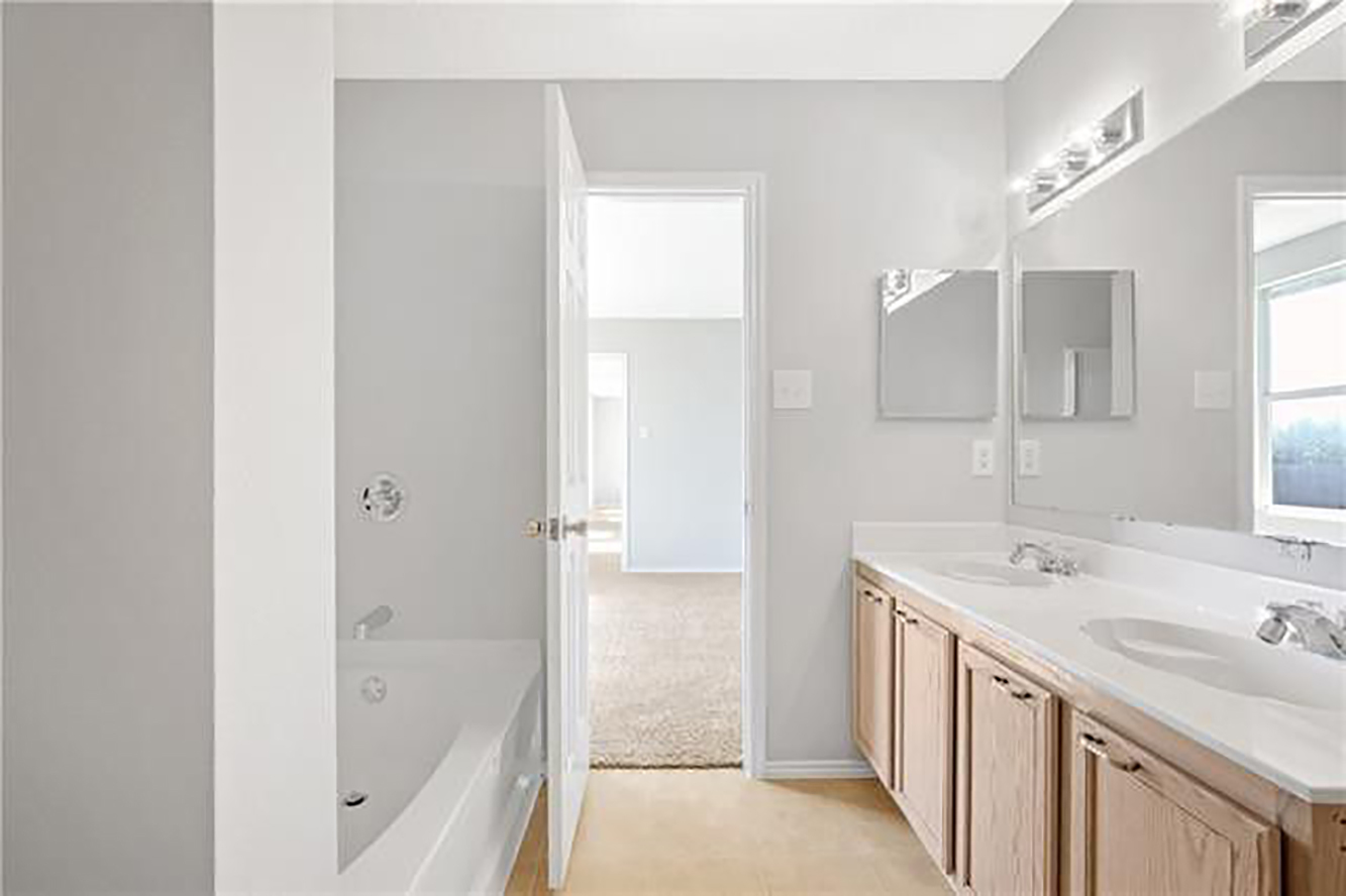 Master bathroom. Upgraded fixtures, granite countertops and woodgrain tile not pictured. - 1419 Windy Meadows Dr