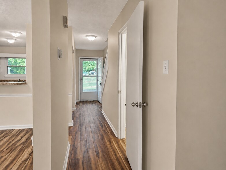 Downstairs hallway looking at front door. - 5484 Pine Top Cir