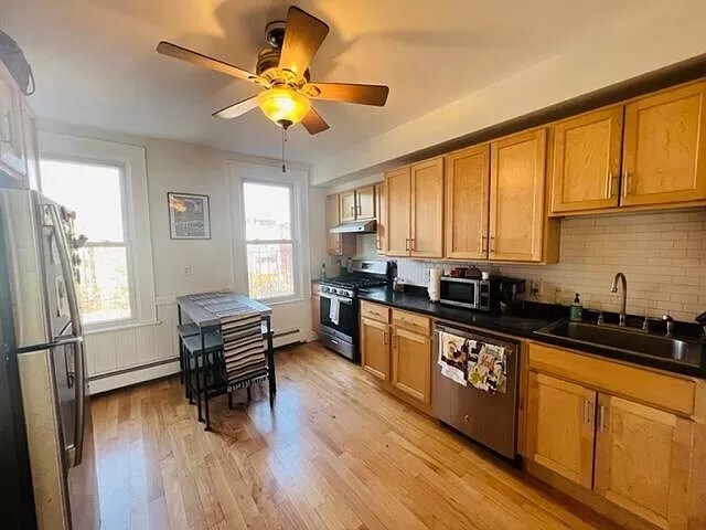 Kitchen windows look out to backyard shared outdoor space - 82 Webster St