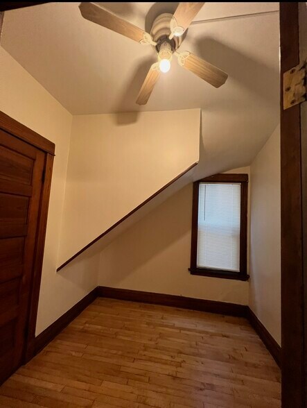 First bedroom with walk-in closet and ceiling fan - 3748 W Lyndale St