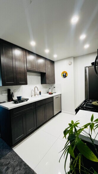 New kitchen with stainless steel refrigerator, dishwasher, stove with built-in air fryer, microwave - 6600 Warner Ave