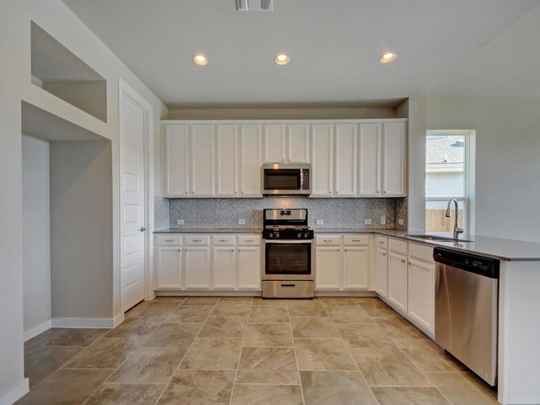 Beautiful kitchen with white cabinets Stainless steel appliances, plus french door stainless steel Samsung refrigerator - 6808 Cardinal Bloom Loop