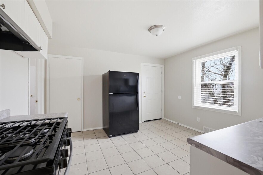 Kitchen facing pantry and rear entry door - 101 W Meinecke Ave