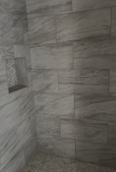 Beautiful tile work on the walk-in shower and encove for convenient access to toiletries. - 4720 Burma Rd