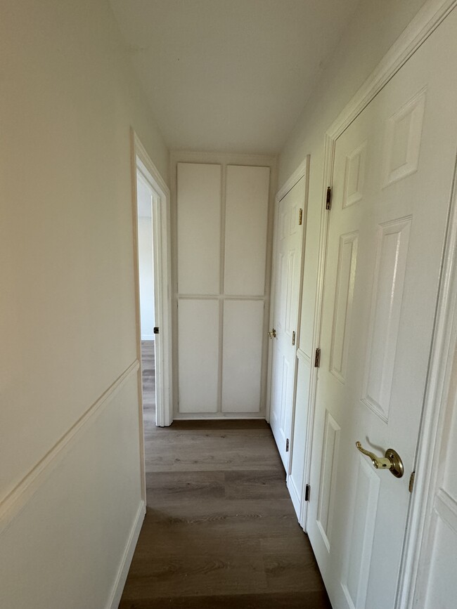 Hallway with walk-in closet and storage cabinets - 2844 E 3rd St