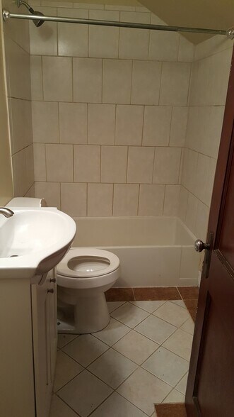 Bathroom ceramic floor & tub surround and deep tub - 404 W Court St