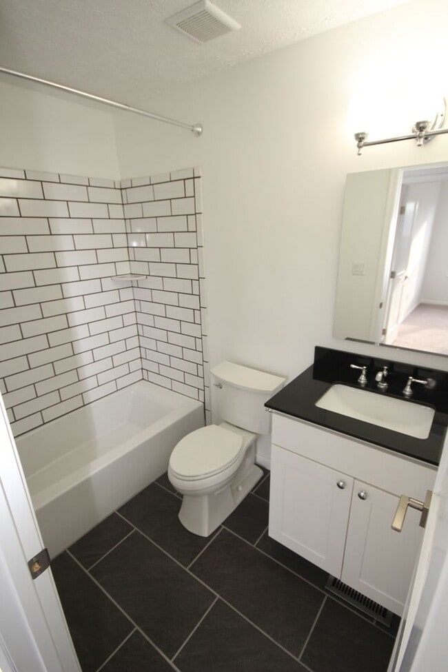 Building Photo - *Coming Soon*  Upgraded End Unit Townhome ...