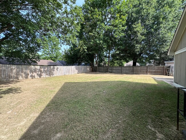 Building Photo - Charming 3BR/2BA Near Southwind | Soaring Vaulted Ceilings, Brick Fireplace & Fenced Yard