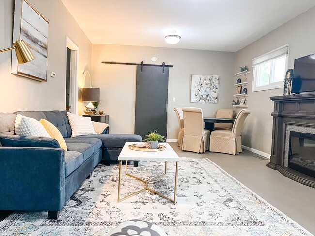 Great room includes sectional, fireplace, new Toshiba Smart TV, lounge chairs and Dining - 2802 Linden Ave