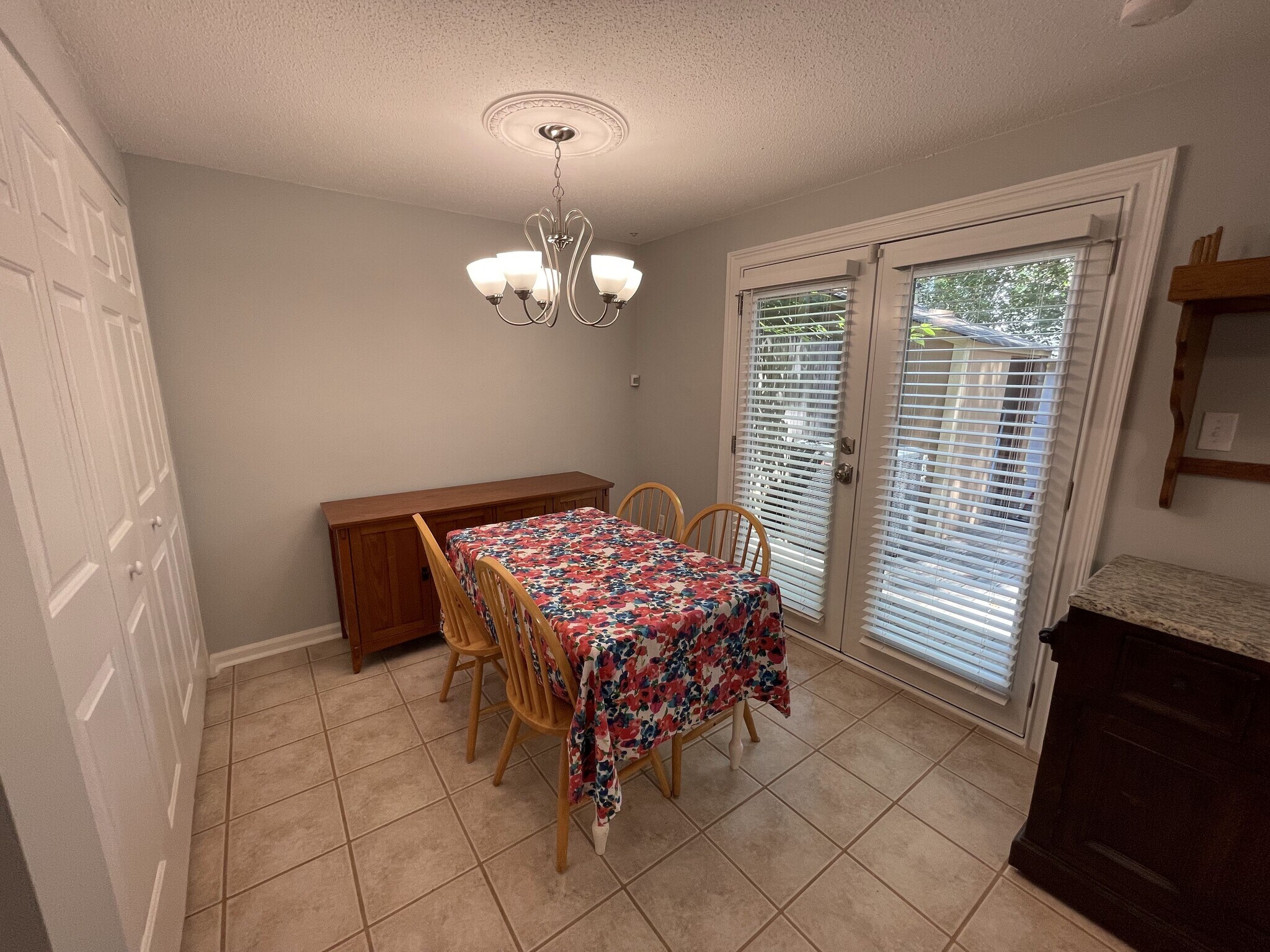 Dining room with french door access to deck, buffet, and chandelier with ceiling medallion - 4204 Whistler Ct
