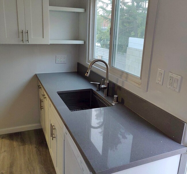 Your Kitchen's Gray Quartz countertops, white cabinets and stainless steel sink - 1828 S Curson Ave