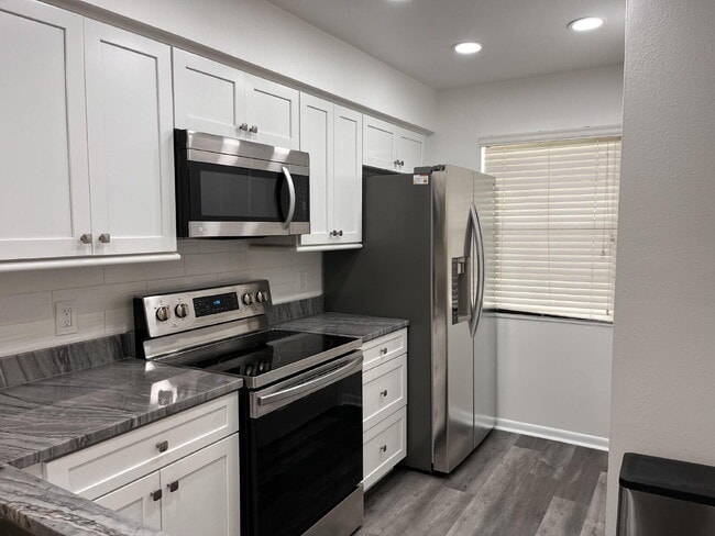 Building Photo - Two-story condominium, featuring 2 bedrooms and 2 1/2 bathrooms