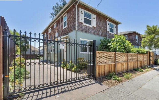 Gated entrance to parking lot and backyard - 667 40th St