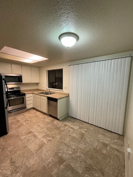 Kitchen with vertical blinds covering sliding door - 5 Del Prado Cir