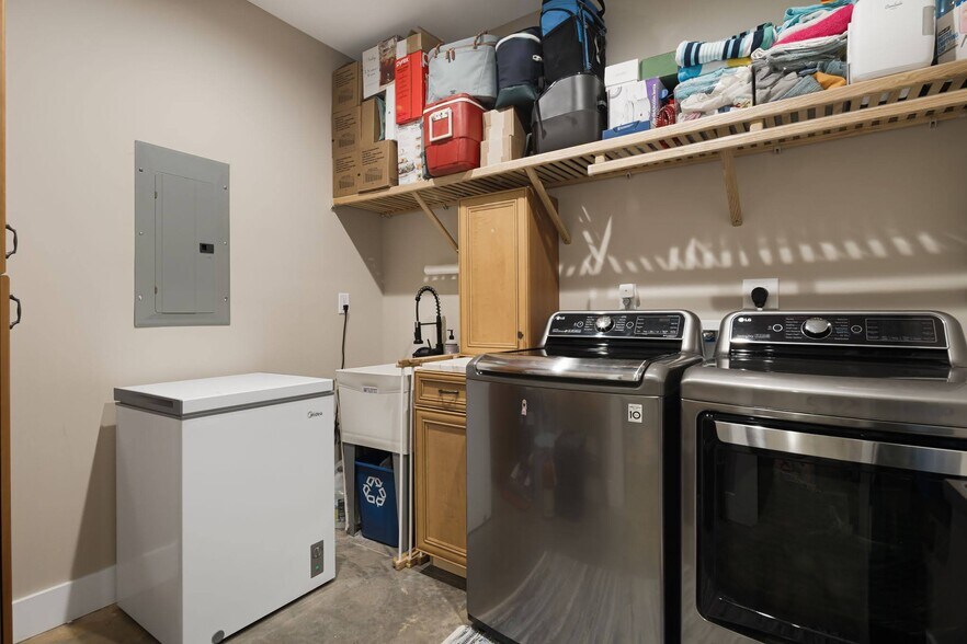 Spacious laundry room with storage and dedicated utility sink on lower-level. - 33 Rex Dr