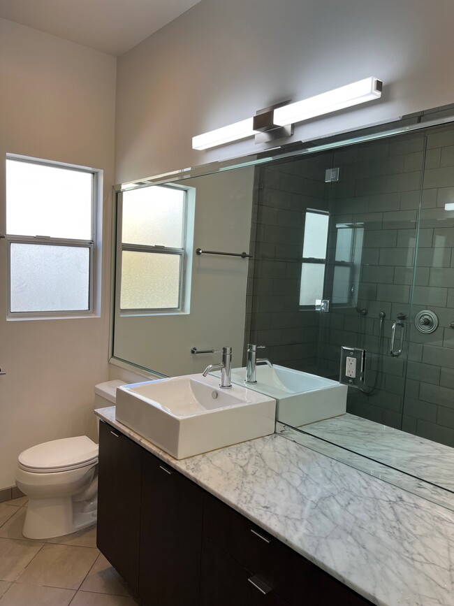 bathroom w/ wall-to-wall framed mirrors - 457 N Spaulding Ave