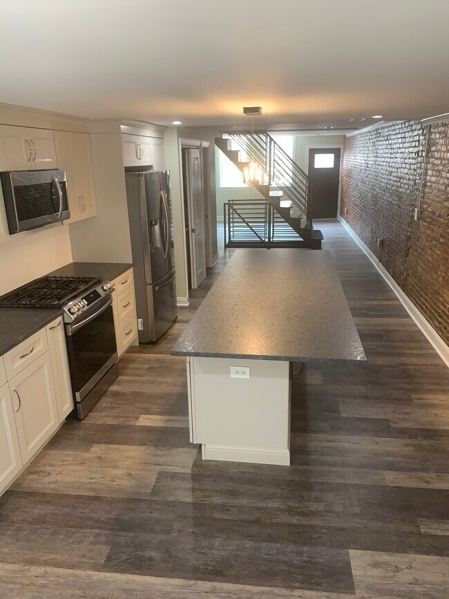 Open Floor Plan features hardwood flooring throughout - 1815 E Hazzard St