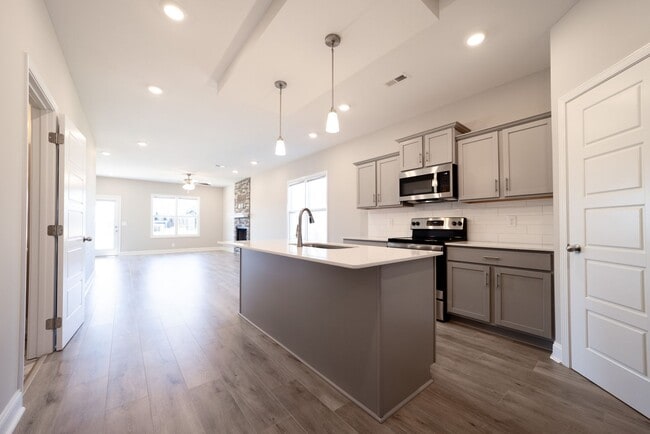 Building Photo - Elegant Home with Stone Fireplace, Kitchen Island and Designer Primary Suite